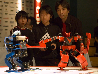 Illustration for article titled Girl Pilots Japanese Fighting Robot With Gundam Master/Slave Control Suit